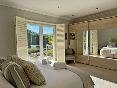 a bedroom with a bed and a large window at Villa Montecastillo - Ole Solutions in Jerez de la Frontera
