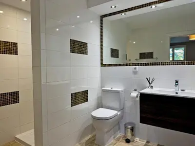 a bathroom with a toilet and a sink and a mirror at Villa Montecastillo - Ole Solutions in Jerez de la Frontera