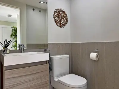 a bathroom with a toilet and a sink and a mirror at Villa Montecastillo - Ole Solutions in Jerez de la Frontera