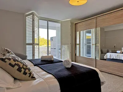 a bedroom with a large bed with a large window at Villa Montecastillo - Ole Solutions in Jerez de la Frontera