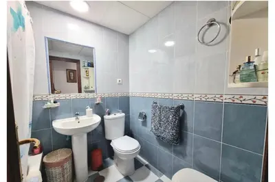 a bathroom with a toilet and a sink at Cruces in El Puerto de Santa María