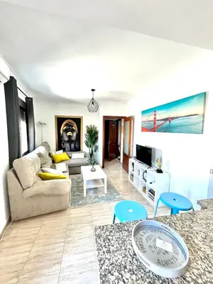 a living room with a couch and a tv at Cruces in El Puerto de Santa María