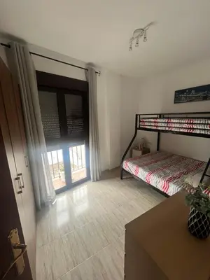 a bedroom with a bed and a door with a window at Cruces in El Puerto de Santa María