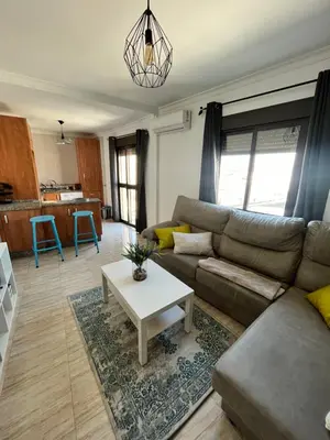 a living room with a couch and a table at Cruces in El Puerto de Santa María