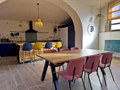 a dining room with a wooden table and chairs at La Bodeguita - Ole Solutions in Jerez de la Frontera