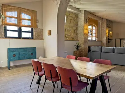 a dining room with a wooden table and chairs at La Bodeguita - Ole Solutions in Jerez de la Frontera