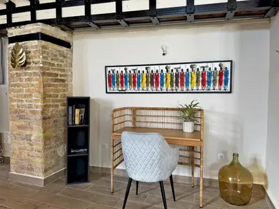 a table and a chair in a room at La Bodeguita - Ole Solutions in Jerez de la Frontera