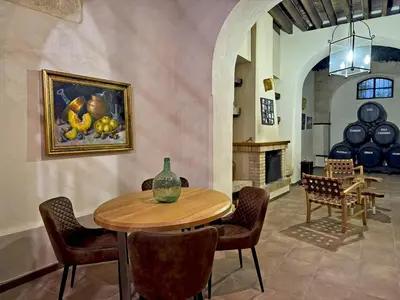 a dining room with a table and a painting on the wall at La Bodeguita - Ole Solutions in Jerez de la Frontera