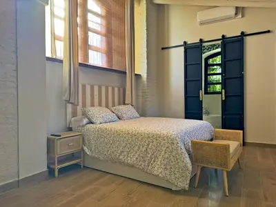 a bedroom with a bed and a window at La Bodeguita - Ole Solutions in Jerez de la Frontera