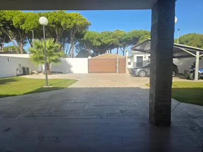 a parking lot with a car parked in a driveway at La caprichosa in Chiclana de la Frontera