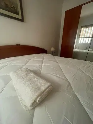 a room with a ceiling fan and a hallway at Espera Apartamentos in Espera