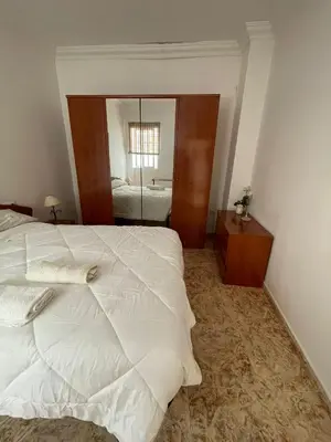 a living room with a wooden table and a tv at Espera Apartamentos in Espera