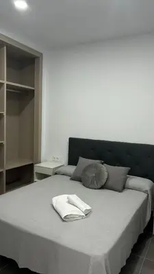 a bed with two towels on top of it at Lacana 2 in Chiclana de la Frontera