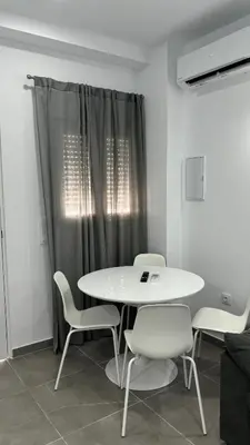 a white table and chairs in a room at Lacana 2 in Chiclana de la Frontera
