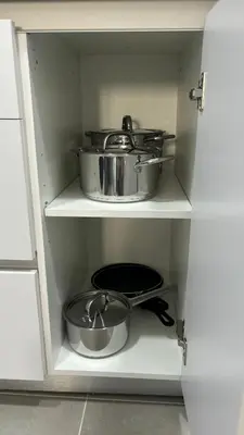 a cabinet with several pots and pans in it at Lacana 2 in Chiclana de la Frontera