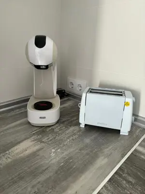 a white coffee maker and a toaster in a room at Lacana 2 in Chiclana de la Frontera