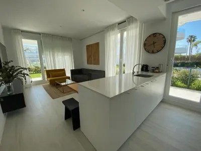 a kitchen with white cabinets and a stove and a microwave at Rinconcito en el Paraíso Costa Ballena in Costa Ballena