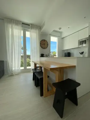 a kitchen and living room with a table and a couch at Rinconcito en el Paraíso Costa Ballena in Costa Ballena
