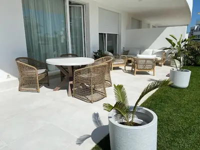 a patio with a table and chairs and a building at Rinconcito en el Paraíso Costa Ballena in Costa Ballena