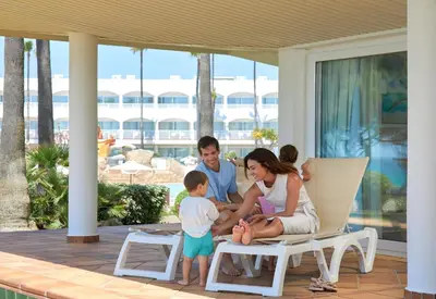 a family playing on the porch of a house at Iberostar Waves Royal Andalus in Chiclana de la Frontera