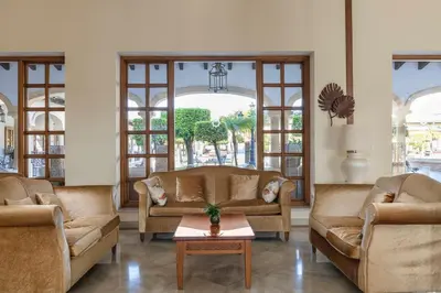 a living room with two couches and a table at Iberostar Selection Andalucia Playa in Chiclana de la Frontera