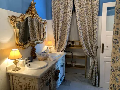 a bathroom with a sink and a mirror at Casa Palacio Jerezana in Jerez de la Frontera