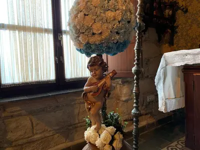 a statue of a little girl playing a violin at Casa Palacio Jerezana in Jerez de la Frontera