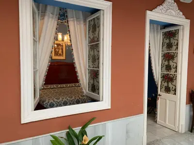 a mirror on the wall of a hallway at Casa Palacio Jerezana in Jerez de la Frontera