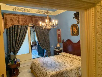 a bedroom with a bed and a window at Casa Palacio Jerezana in Jerez de la Frontera