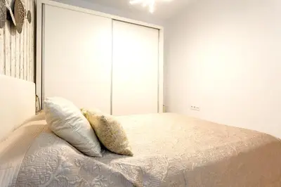 a bedroom with a bed with two pillows on it at precioso piso en playa caleta in Cádiz