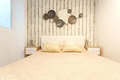a bedroom with a large bed with two night stands at precioso piso en playa caleta in Cádiz