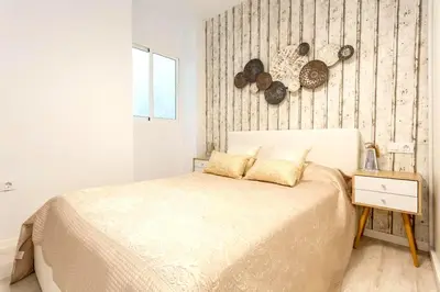 a bedroom with a bed and a wall with fossils at precioso piso en playa caleta in Cádiz