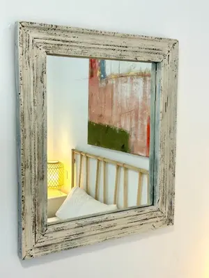 an old mirror hanging on a wall at El Palacito 