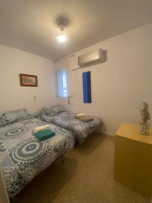 a bedroom with two twin beds and a window at Casa Alzar in Jerez de la Frontera