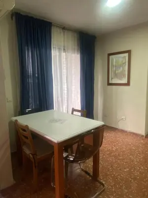 a table and chairs in a room with a window at Casa Alzar in Jerez de la Frontera