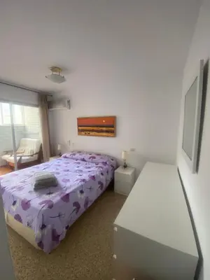 a bedroom with a bed with a purple comforter at Casa Alzar in Jerez de la Frontera