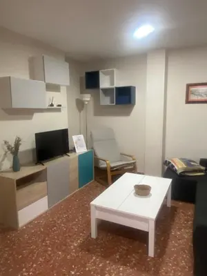 a living room with a white table and a couch at Casa Alzar in Jerez de la Frontera