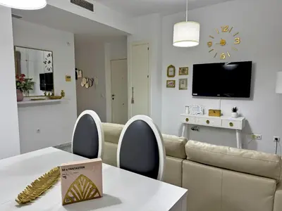 a living room with a table and a couch at Apartamento La Frontera - Ole Solutions in Jerez de la Frontera