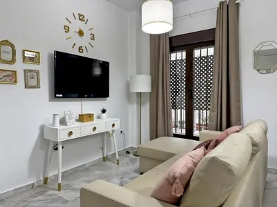a living room with a couch and a tv at Apartamento La Frontera - Ole Solutions in Jerez de la Frontera