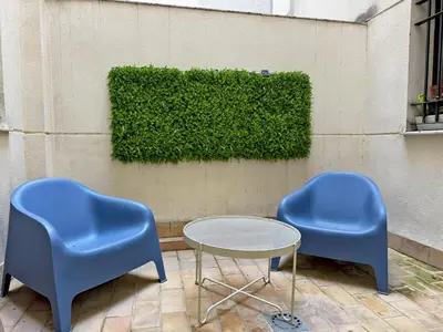 two blue chairs and a table in front of a wall at Apartamento La Frontera - Ole Solutions in Jerez de la Frontera