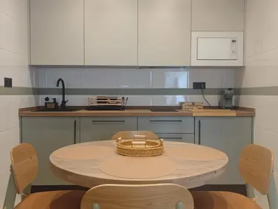 a kitchen with a table with a basket on it at Le Charme Little Apartments in Cádiz
