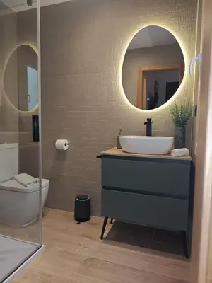 a bathroom with a sink and a toilet and a mirror at Le Charme Little Apartments in Cádiz