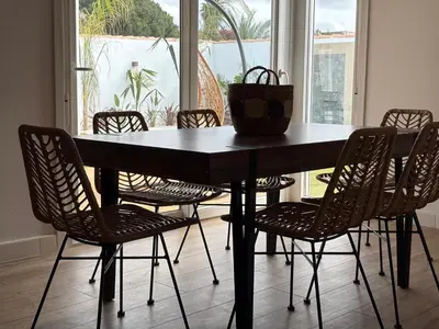 a dining room table with chairs and a large window at GUACA 2 in Cádiz