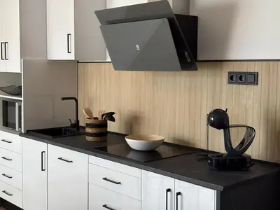 a kitchen with a black counter top with a hood at GUACA 2 in Cádiz
