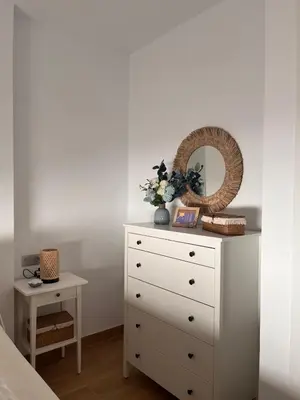 a white dresser with a mirror and a table at Recidencial Cruz del Mar 