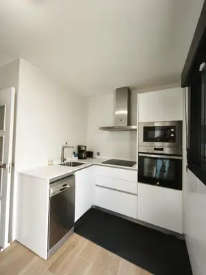 a white kitchen with a sink and a microwave at Recidencial Cruz del Mar 