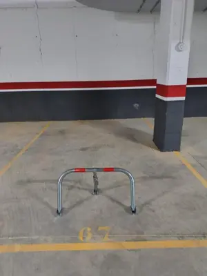 a metal pipe in a parking lot next to a building at Recidencial Cruz del Mar 