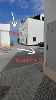 a white building with the words playa urbanization on it at Recidencial Cruz del Mar 