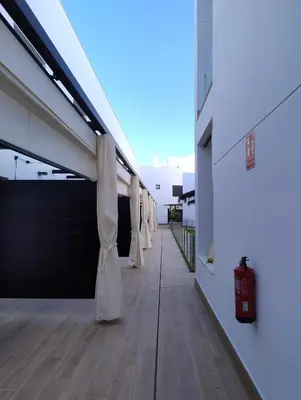 a hallway with white curtains on the side of a building at Recidencial Cruz del Mar 