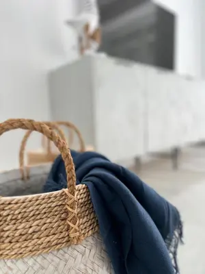 a wicker basket with a blue blanket in it at Victoria Centro 34 in Puerto Real